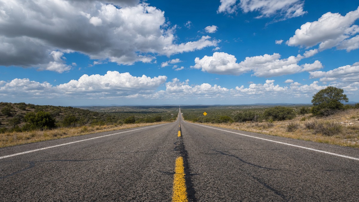 A cinematic Texas highway stretching to the horizon under a dramatic cloud-filled blue sky, evoking the Don't Mess with Texas spirit